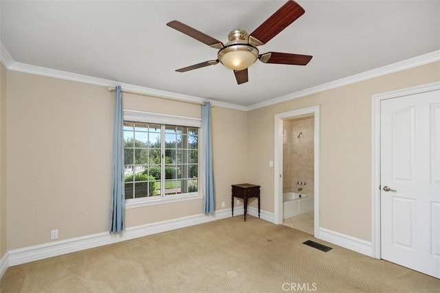 spare room featuring ceiling fan, light colored carpet, and crown molding