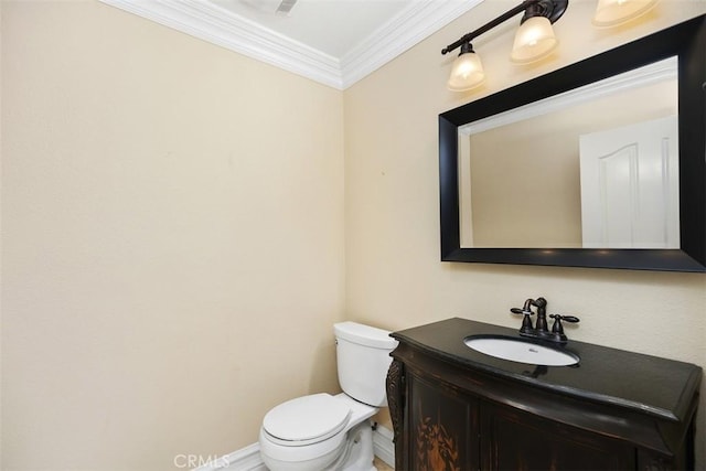 bathroom with vanity, toilet, and ornamental molding