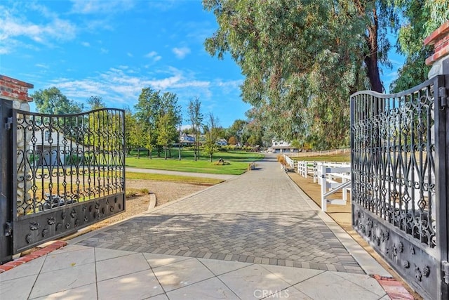 view of gate featuring a lawn