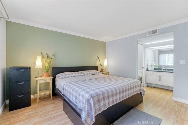 bedroom featuring connected bathroom, light hardwood / wood-style flooring, and ornamental molding