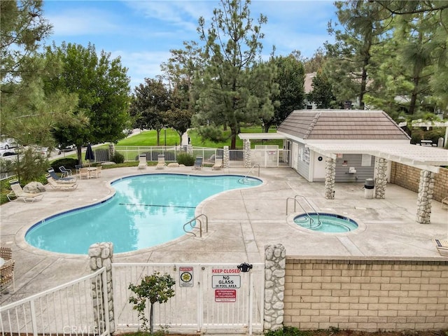 view of pool featuring a patio and a hot tub