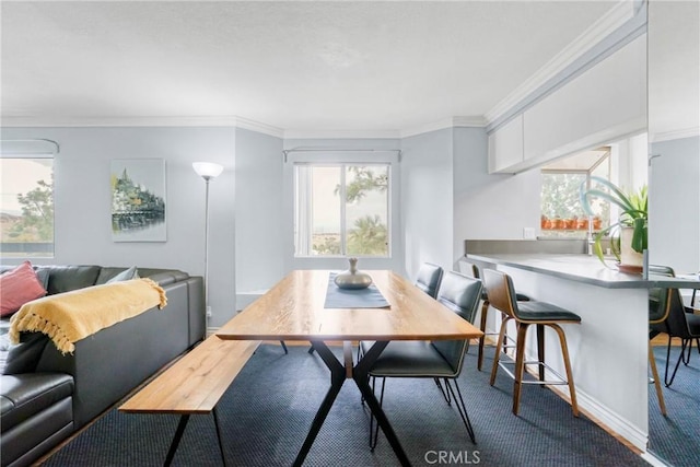 dining space with crown molding