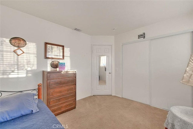 carpeted bedroom with a closet