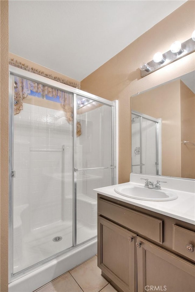 bathroom with vanity, tile patterned floors, and an enclosed shower