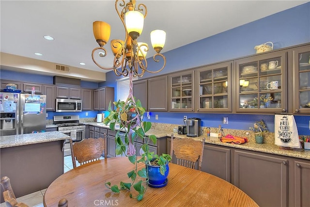 tiled dining area with a chandelier