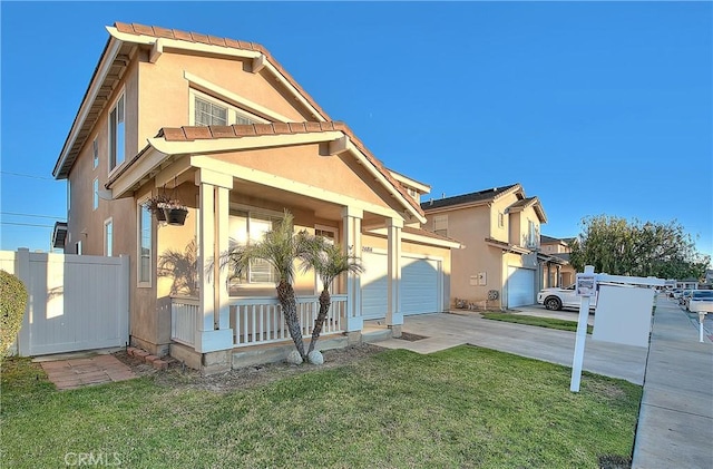 view of front of house featuring a porch, a garage, and a front yard