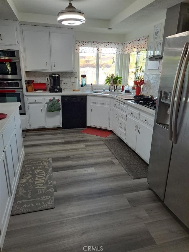 kitchen featuring black appliances, white cabinets, dark wood-type flooring, and tasteful backsplash