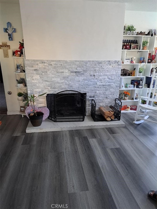 details featuring a stone fireplace and hardwood / wood-style floors