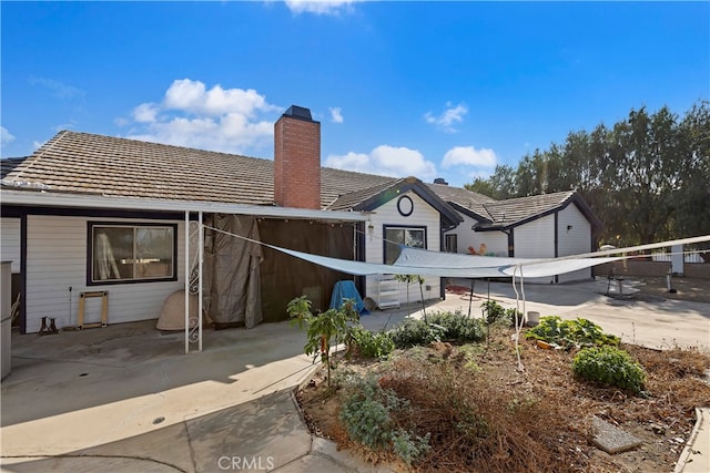 rear view of property featuring a patio area