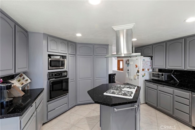 kitchen featuring island range hood, a kitchen island, gray cabinetry, and white appliances