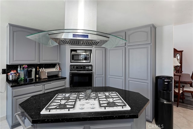 kitchen with island exhaust hood, white gas cooktop, stainless steel microwave, black oven, and gray cabinets