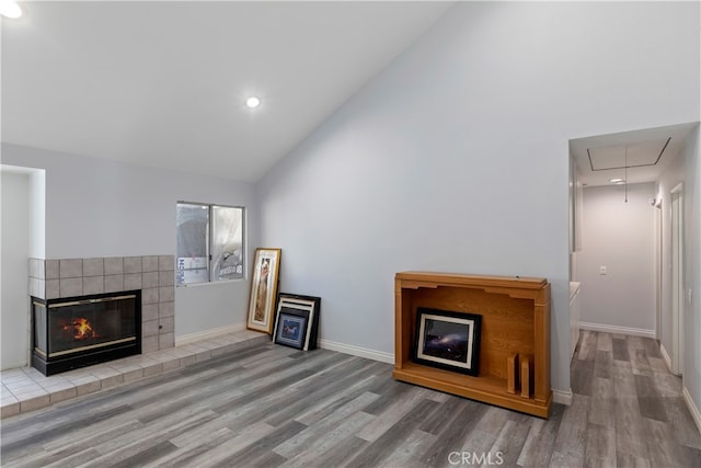 unfurnished living room with high vaulted ceiling and hardwood / wood-style floors