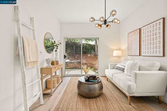 living room with hardwood / wood-style floors and a notable chandelier