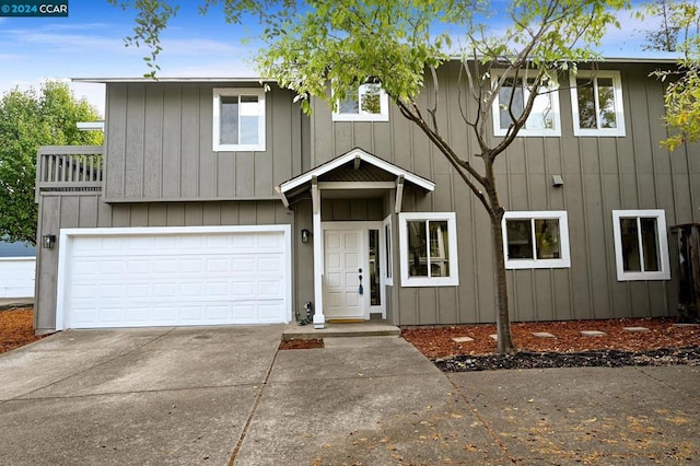 view of front facade with a balcony and a garage