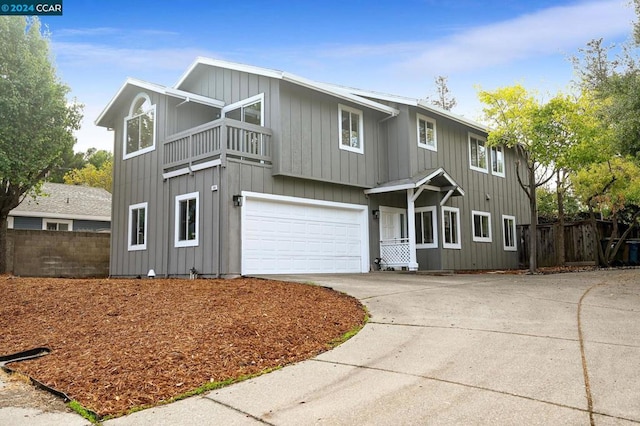 front facade featuring a garage and a balcony