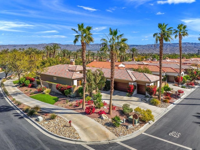 birds eye view of property with a mountain view