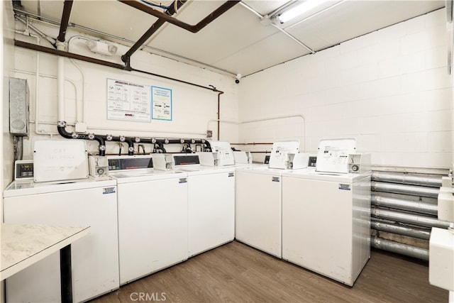 clothes washing area featuring washer and clothes dryer and hardwood / wood-style flooring