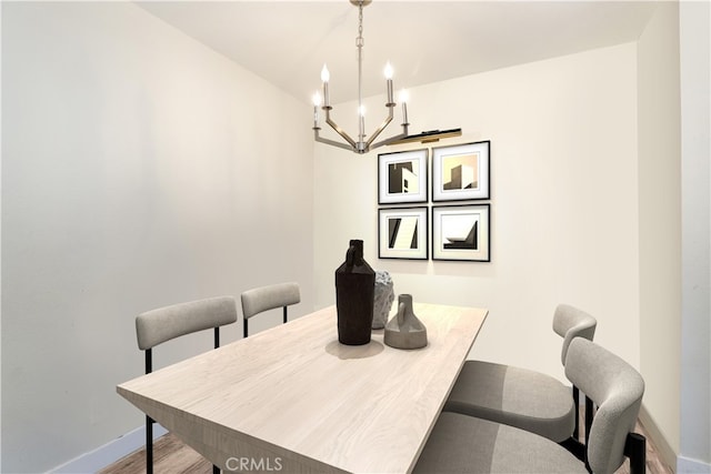 dining room featuring a notable chandelier and wood-type flooring