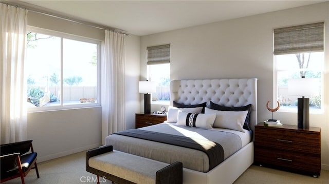 carpeted bedroom featuring multiple windows