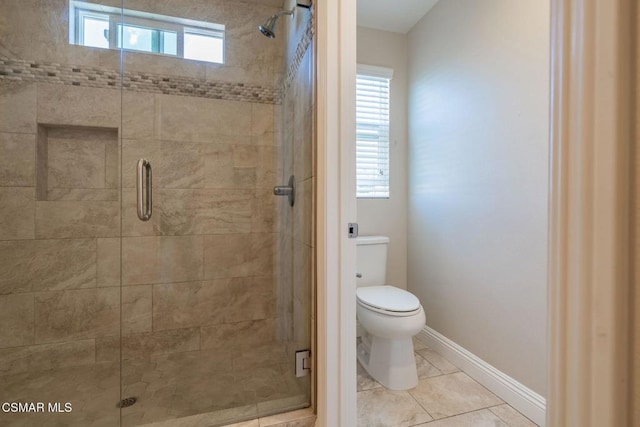 bathroom featuring toilet, a shower with shower door, and tile patterned flooring