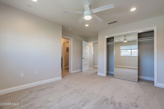 unfurnished bedroom with a closet, ceiling fan, and light carpet