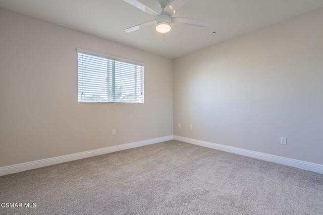 unfurnished room with light colored carpet and ceiling fan