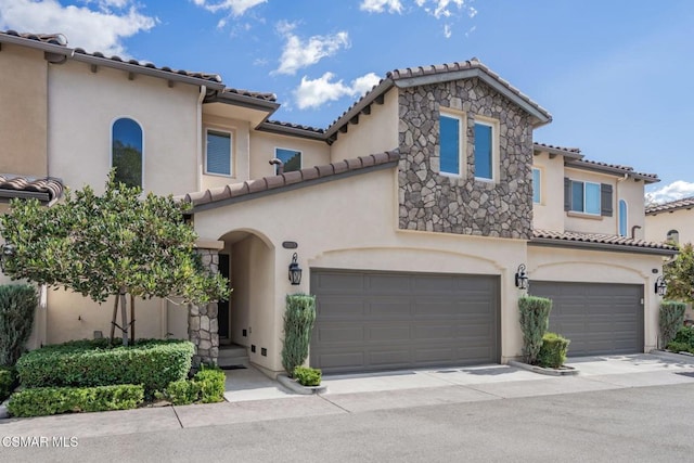 mediterranean / spanish house featuring a garage