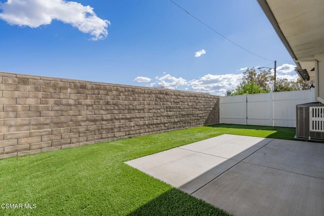 view of yard featuring a patio area and central AC