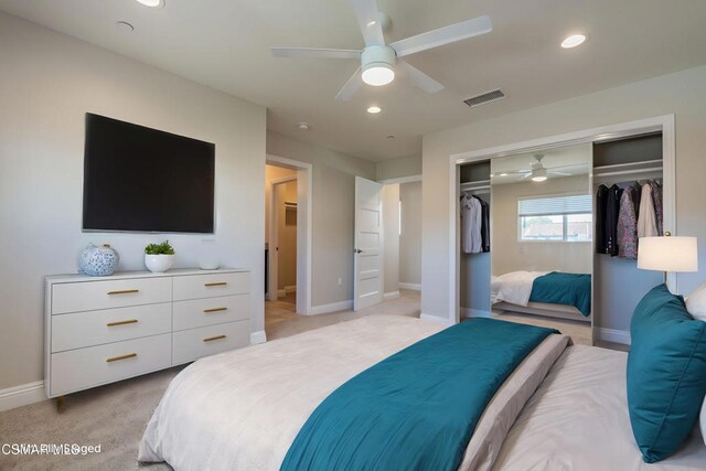 carpeted bedroom with a closet and ceiling fan