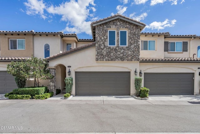 mediterranean / spanish home with a garage