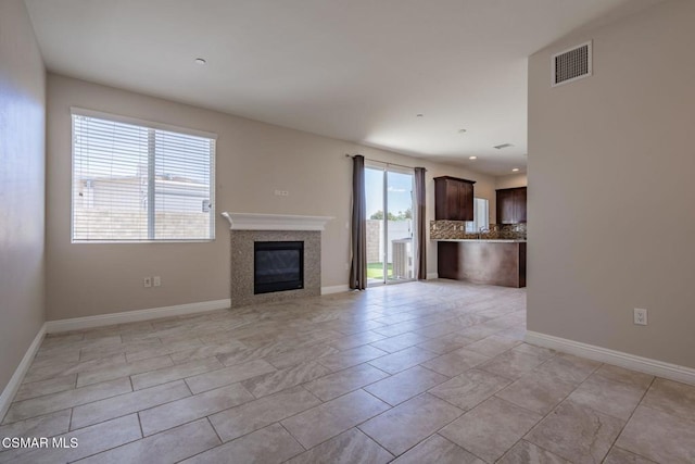 unfurnished living room with a wealth of natural light