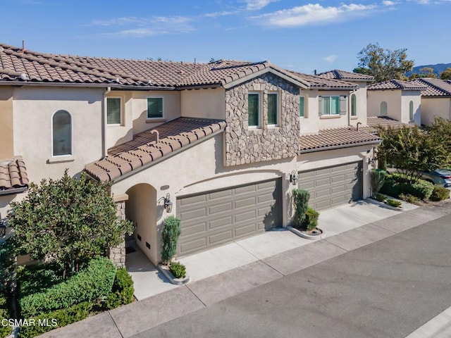 mediterranean / spanish house featuring a garage