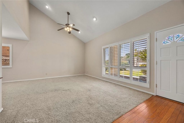 entryway featuring ceiling fan, a healthy amount of sunlight, wood-type flooring, and high vaulted ceiling