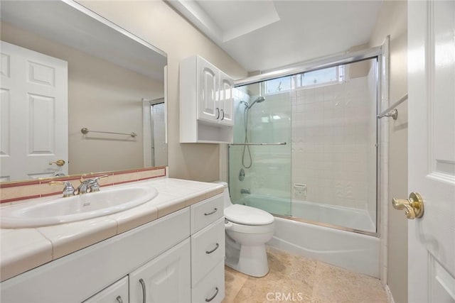 full bathroom with vanity, enclosed tub / shower combo, and toilet