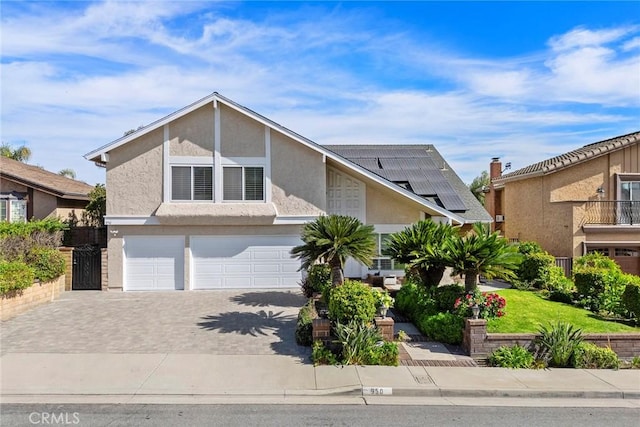 view of front of home with a garage and solar panels