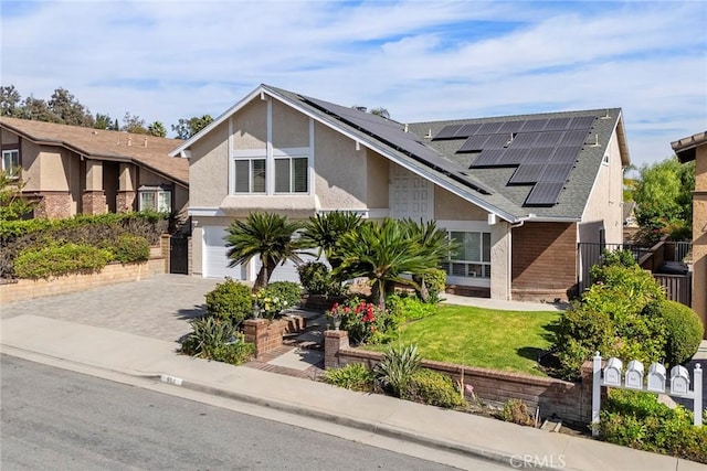 tudor house featuring a front yard and a garage