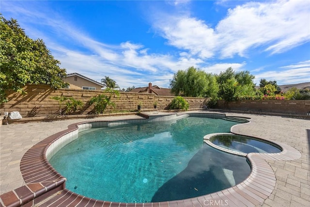 view of pool featuring an in ground hot tub and a patio