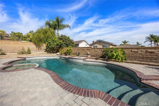 view of pool with an in ground hot tub and a patio area