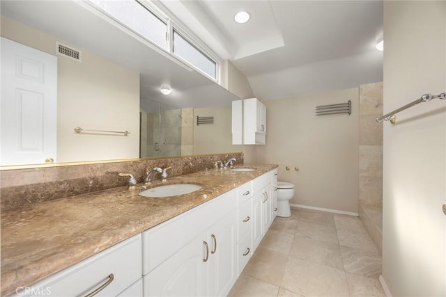 bathroom featuring tile patterned floors, a tile shower, vanity, toilet, and lofted ceiling