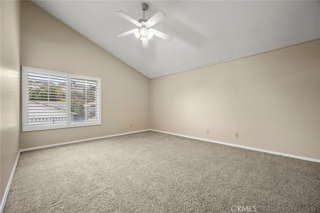 carpeted spare room with ceiling fan and high vaulted ceiling