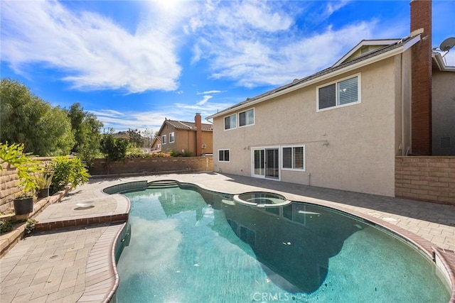 view of swimming pool featuring a patio area and an in ground hot tub