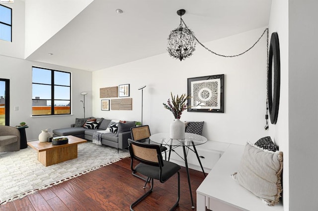 living room with hardwood / wood-style floors and an inviting chandelier