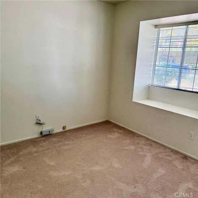 empty room featuring light colored carpet