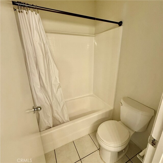 bathroom featuring toilet, shower / bathtub combination with curtain, and tile patterned flooring