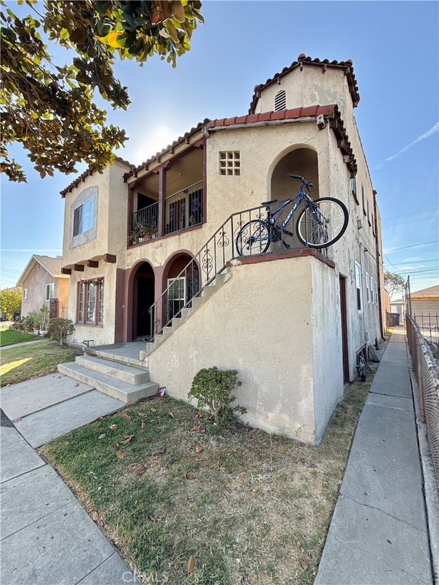 mediterranean / spanish-style home with a balcony