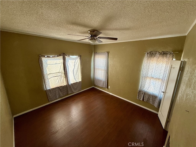 unfurnished room with crown molding, a textured ceiling, dark wood-type flooring, and ceiling fan