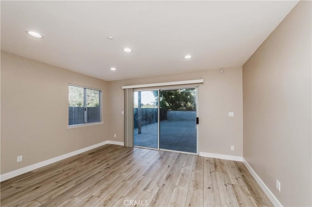 spare room with light hardwood / wood-style floors