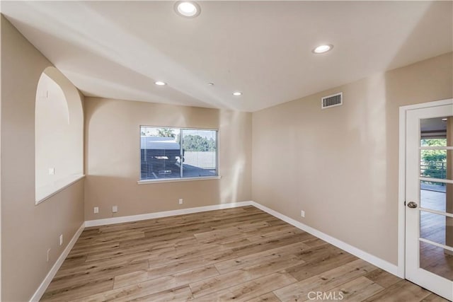 spare room with light wood-type flooring and a wealth of natural light