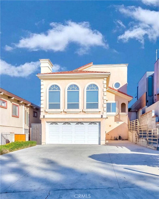 mediterranean / spanish-style home featuring a garage