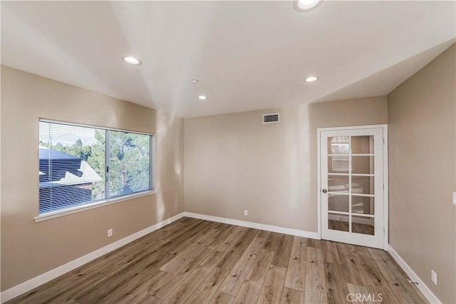 spare room with light hardwood / wood-style floors